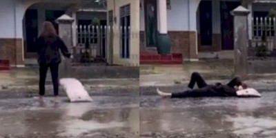 Video Viral, Wanita Ini dengan Santainya Tidur di Jalan Becek Saat Hujan