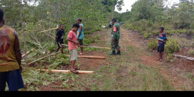 Babinsa Bantu Warga Binaan Bersihkan Kebun di Desa Warbon