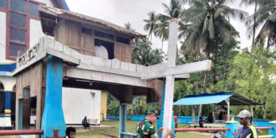 Babinsa Koramil 1708-05/Numfor Bantu Penancapan Tugu Salib di Halaman Gereja