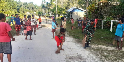 Babinsa Karya Bakti Bersama Masyarakat Membersihkan Rumput Liar 