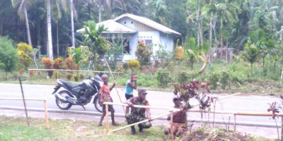 Sambut Hari Raya Paskah, Babinsa Biak Utara Bantu Warga Pasang Hiasan Tanda Salib